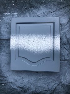 Cabinet door during paint spraying process